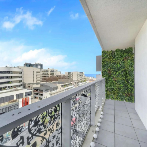 vertical artificial green wall in the balcony